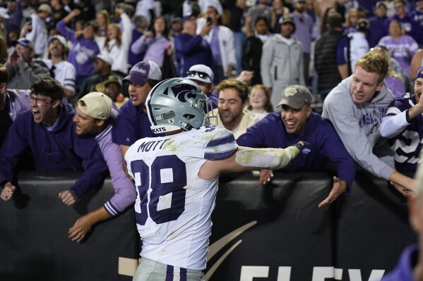 Kansas State defensive end Brendan Mott is congratulated by fans after an NCAA college football game against Colorado Saturday, Oct. 12, 2024, in Boulder, Colo. (AP Photo/David Zalubowski)