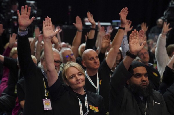 Unite General Secretary Sharon Graham, foreground left vote with other delegates in favour of a motion calling for the winter fuel cut to be reversed during the Labour Party Conference at the ACC Liverpool, in Liverpool, England, Wednesday, Sept. 25, 2024. (Stefan Rousseau/PA via AP)