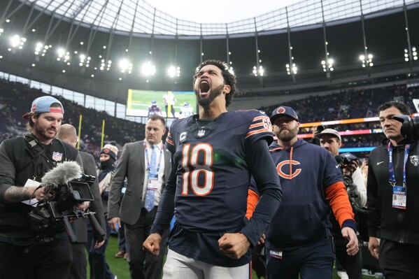 Chicago Bears quarterback Caleb Williams (18) reacts as he leaves the field after an NFL football game at the Tottenham Hotspur stadium between the Jacksonville Jaguars and Chicago Bears in London, Sunday, Oct. 13, 2024. (AP Photo/Alastair Grant)