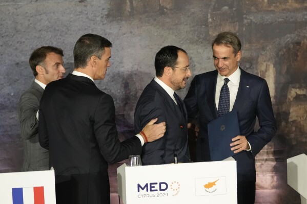 From left to right French President Emmanuel Macron, Spain's Prime minister Pedro Sanchez, Cyprus' President Nikos Christodoulides, and Greece's Prime Minister Kyriakos Mitsotakis chat after the end of a press conference in Paphos ,Cyprus, on Friday, Oct 11, 2024 as the leaders of nine southern European Union member countries and Jordan are meeting to come up with ways of de-escalating the conflict in the Middle East (AP Photo/Petros Karadjias)