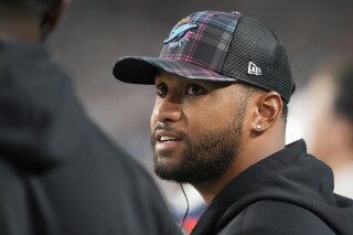 Miami Dolphins quarterback Tua Tagovailoa talks on the sidelines during the second half of an NFL football game against the Tennessee Titans, Monday, Sept. 30, 2024, in Miami Gardens, Fla. (AP Photo/Rebecca Blackwell)