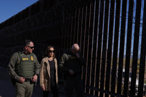 Democratic presidential nominee Vice President Kamala Harris talks with John Modlin, the chief patrol agent for the Tucson Sector of the U.S. Border Patrol, right, and Blaine Bennett, the U.S. Border Patrol Douglas Station border patrol agent in charge, as she visits the U.S. border with Mexico in Douglas, Ariz., Friday, Sept. 27, 2024. (AP Photo/Carolyn Kaster)