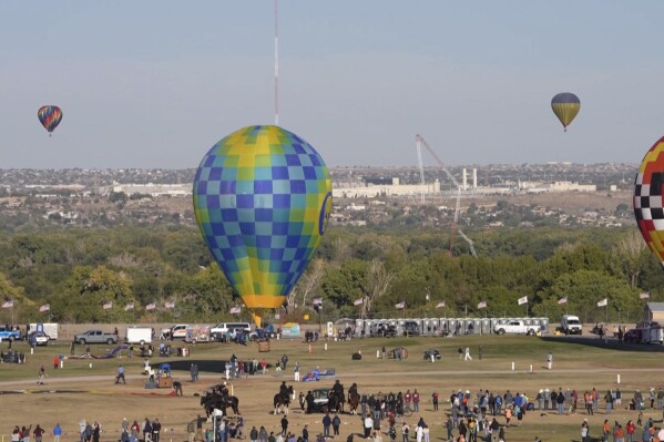 This image made from a video provided by Curt Fargo shows a radio tower collapsing after a hot-air balloon struck it during the famous festival in Albuquerque, N.M., Oct. 11, 2024. (Curt Fargo via AP)