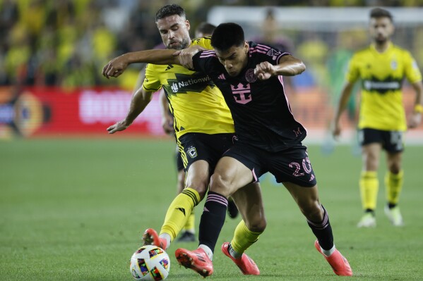 Inter Miami's Diego Gomez, right, and Columbus Crew's Rudy Camacho chase the ball during the first half of an MLS soccer match Wednesday, Oct. 2, 2024, in Columbus, Ohio. (AP Photo/Jay LaPrete)