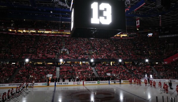 The number 13, worn by former Calgary Flames player Johnny Gaudreau, is displayed during a memorial ceremony prior to an NHL hockey game against the Philadelphia Flyers in Calgary, Alberta, Saturday, Oct. 12, 2024. (Jeff McIntosh/The Canadian Press via AP)