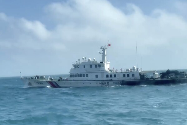 In this screen grab from video released by the Taiwan Coast Guard, a view of a China Coast Guard boat from a Taiwan Coast Guard boat as it passes near the coast of Matsu islands, Taiwan on Monday, Oct. 14, 2024. (Taiwan Coast Guard via AP)