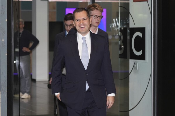 Former Immigration Minister Robert Jenrick leaves after appearing on the BBC One current affairs programme, Sunday with Laura Kuenssberg, ahead of the Conservatives annual conference where a new leader will be chosen, in Birmingham, England, Sunday Sept. 29, 2024. (Jacob King/PA via AP)