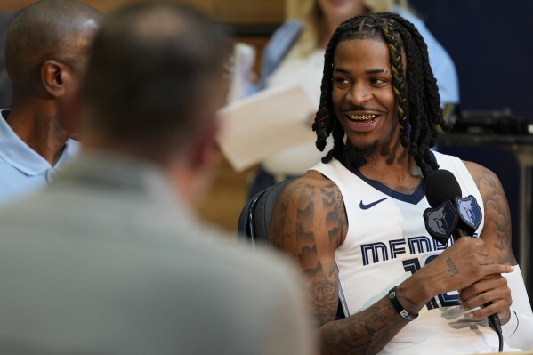 Memphis Grizzlies guard Ja Morant, left, sits for an interview during the NBA basketball team's media day Monday, Sept. 30, 2024 in Memphis, Tenn. (AP Photo/George Walker IV)