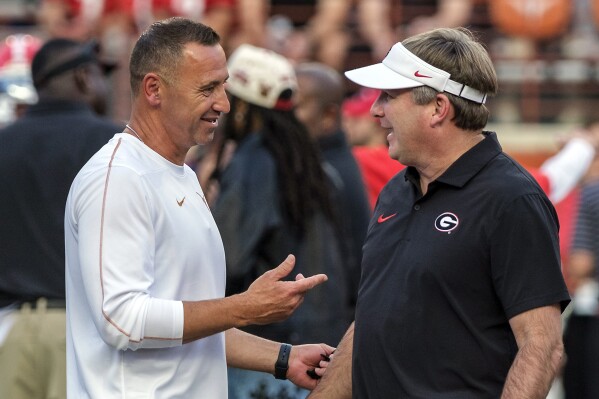 Texas head coach Steve Sarkisian, left, and Georgia head coach Kirby Smart talk during the pregame of an NCAA college football game in Austin, Texas, Saturday, Oct. 19, 2024. (AP Photo/Rodolfo Gonzalez)