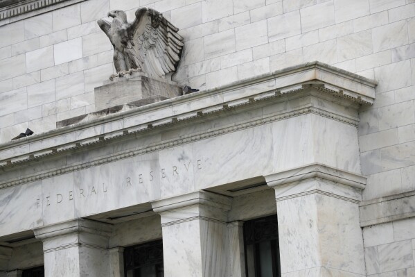 FILE - The Federal Reserve building on May 22, 2020, in Washington. Companies continued rewarding investors with healthy dividends in 2023 even as they tread more cautiously with returning profits through stock buybacks. Inflation has been easing, but it still remains higher than the Federal Reserve would like. (AP Photo/Patrick Semansky, File)