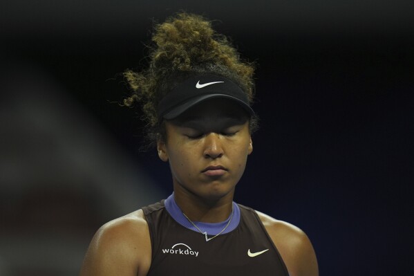 Naomi Osaka of Japan reacts during play against Coco Gauff of the United States in a women's singles match for the China Open tennis tournament held at the National Tennis Center in Beijing, Tuesday, Oct. 1, 2024. (AP Photo/Ng Han Guan)