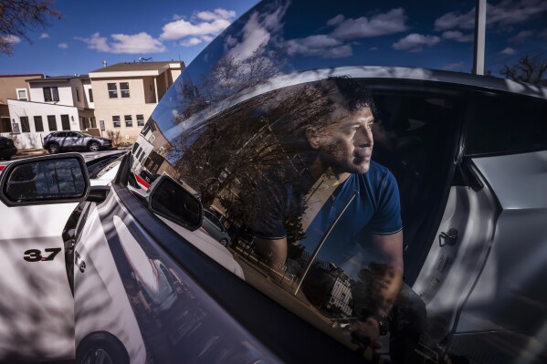 Carlos Sandoval-Smith, who detailed his encounters with an Albuquerque police officer and a law firm implicated in a DWI corruption probe, poses in Albuquerque, N.M., Thursday, Feb. 23, 2024. (Chancey Bush/The Albuquerque Journal via AP)