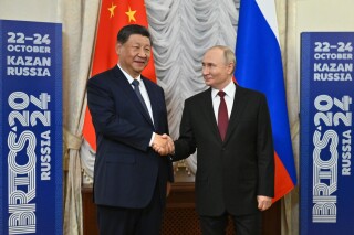 Russian President Vladimir Putin, right, and Chinese President Xi Jinping shake hands during their meeting on the sidelines of BRICS Summit at Kazan Kremlin in Kazan, Russia, Tuesday, Oct. 22, 2024. (Kristina Kormilitsyna/Photo host brics-russia2024.ru via AP)