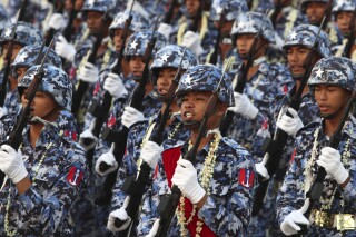 FILE - Military officers march during a parade to commemorate Myanmar's 78th Armed Forces Day in Naypyitaw, Myanmar, on March 27, 2023. Myanmar’s military government on Saturday Feb. 10, 2024 activated for the first time a decade-old conscription law that makes young men and women subject to at least two years of military service if called up, effective immediately. (AP Photo/Aung Shine Oo, File)