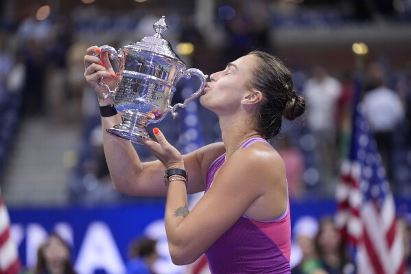 Aryna Sabalenka, of Belarus, kisses the trophy after winning the women's singles final of the U.S. Open tennis championships against Jessica Pegula, of the United States, , Saturday, Sept. 7, 2024, in New York. (AP Photo/Frank Franklin II)