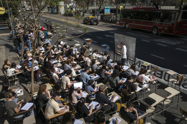 Economics students hold class outside, in front of the University of Buenos Aires to protest President Javier Milei's veto of a law to increase funding for public universities, in Buenos Aires, Argentina, Oct. 16, 2024. (AP Photo/Victor R. Caivano)