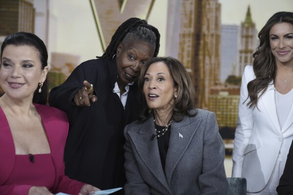 Democratic presidential nominee Vice President Kamala Harris chats with the hosts during a commercial break at The View, Tuesday, Oct. 8, 2024, in New York. From left are Ana Navarro, Whoopi Goldberg, Harris and Alyssa Farah Griffin. (AP Photo/Jacquelyn Martin)