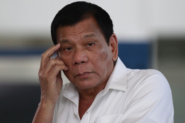 FILE -Philippine President Rodrigo Duterte listens to a question from reporters at Manila's International Airport, Philippines on, Nov. 9, 2016. (AP Photo/Aaron Favila, File)