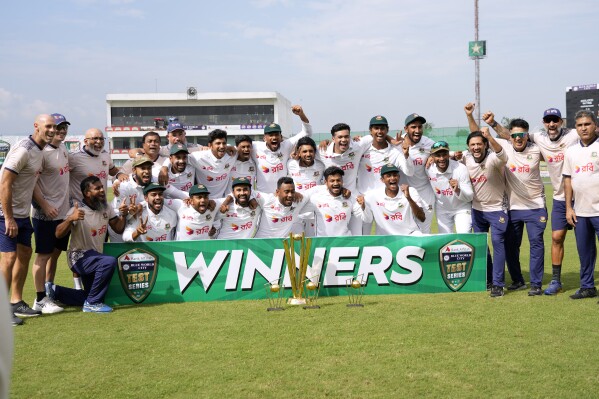 Bangladesh's officials and players pose for photograph after winning test cricket series against Pakistan, in Rawalpindi, Pakistan, Tuesday, Sept. 3, 2024. (AP Photo/Anjum Naveed)