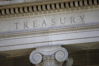 FILE- This photo shows the U.S. Treasury Department building at dusk in Washington, June 6, 2019. (AP Photo/Patrick Semansky, File)