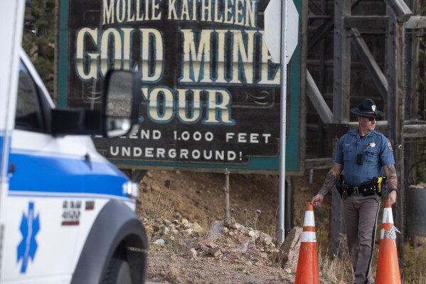 A police officer moves a barrier for an emergency vehicle Thursday, Oct. 9, 2024, at Mollie Kathleen Gold Mine in Cripple Creek, Colo. (Arthur H. Trickett-Wile/The Gazette via AP)