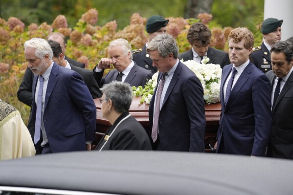 Pallbearers Max Kennedy, left, Chris Kennedy, behind center left, both sons of the late Ethel Kennedy, and Matt Kennedy, center front, and, Joseph Kennedy III, front second from right, both grandsons of Ethel Kennedy, carry her casket from Our Lady of Victory church, following funeral services, Monday, Oct. 14, 2024, in Centerville, Mass. (AP Photo/Steven Senne)