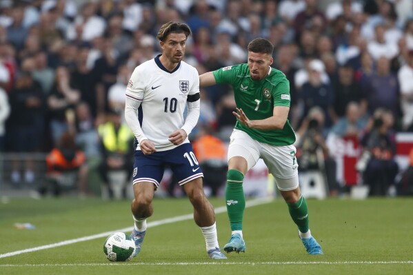 Ireland's Matt Doherty, right, vies for the ball with England's Jack Grealish during the UEFA Nation's League soccer match between Ireland and England at the Aviva stadium in Dublin, Ireland, Saturday, Sept. 7, 2024. (AP Photo/Peter Morrison)