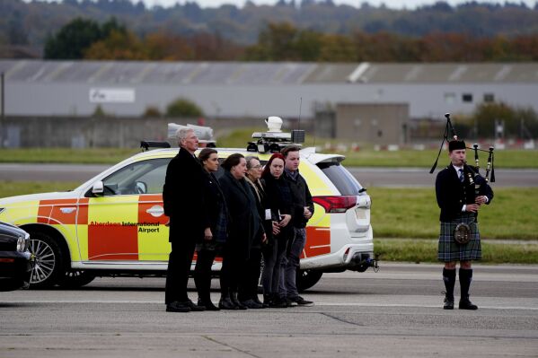 Members of the family and acting Alba leader Kenny MacAskill, left, greet the coffin of former first minister of Scotland Alex Salmond at Aberdeen Airport, Friday Oct. 18, 2024. (Jane Barlow/PA via AP)