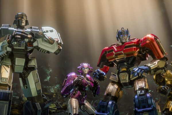 This image released by Paramount Pictures shows characters, from left, D-16/Megatron, voiced by Brian Tyree Henry, Elita-1, voiced by Scarlett Johansson, Orion Pax/Optimus Prime, voiced by Chris Hemsworth, and B-127, voiced by Keegan-Michael Key, in a scene from "Transformers One." (Paramount Pictures via AP)