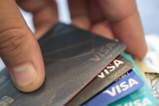 FILE - Visa credit cards in New Orleans, Aug. 11, 2019. Consumers are increasingly struggling to pay their credit card bills, raising concerns about severe delinquencies spiraling and sapping consumer spending. (AP Photo/Jenny Kane, File)