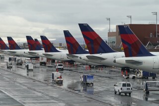 FILE - Delta planes are shown at their gates June 13, 2022, at Salt Lake City International Airport, in Salt Lake City. Major airlines including United Airlines, Delta and American expect fuel costs to keep rising through the end of the year, putting a dent in profits for an industry that has seen earnings growth in 2023. (AP Photo/Rick Bowmer, File)