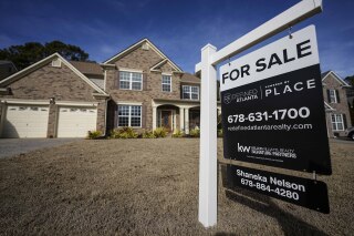 FILE - A sign announcing a home for sale is posted outside a home, Feb. 1, 2024, in Aceworth, Ga., near Atlanta. One of the reasons for the sharp run-up in home loan borrowing costs the last couple of years has been a wider-than-normal gap between long-term mortgage rates and the yield on the benchmark U.S. government bond. (AP Photo/Mike Stewart)