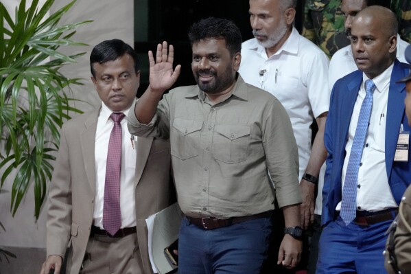 Marxist lawmaker Anura Kumara Dissanayake waves as he departs the election commission office after winning the presidential election in Colombo, Sri Lanka, Sunday, Sept. 22, 2024. (AP Photo/Eranga Jayawardena)