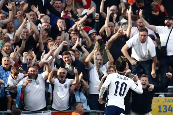 England's Jack Grealish, celebrates towards his side fans after scoring his sides second goal during the UEFA Nation's League soccer match between Ireland and England at the Aviva stadium in Dublin, Ireland, Saturday, Sept. 7, 2024. (AP Photo/Peter Morrison)