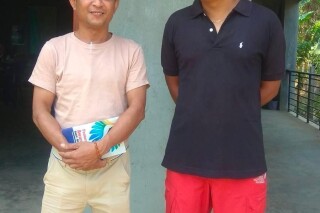 Aung San Oo, left, and Myo Myint Oo, pose for a picture in front of the office of the Tanintharyi Weekly Journal published by Dawei Watch media, in Dawei township in Tanintharyi region, Myanmar, in 2020. A military court in Myanmar has given a life prison sentence to a local journalist and sentenced one of his colleagues to 20 years after convicting them under a counterterrorism law, their editor said Wednesday. (Zaw Zaw (Myeik) via AP)