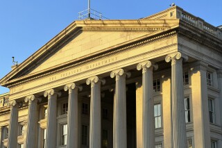 FILE - The Treasury Department is seen near sunset in Washington, Jan. 18, 2023. The Biden administration is rolling out new recordkeeping rules for U.S. investment advisers in its continued effort to clamp down on money laundering, illicit finance and fraud in the American financial system. (AP Photo/Jon Elswick, File)