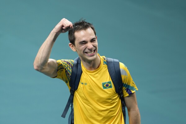 Brazil's Hugo Calderano reacts after his win against South Korea's Jang Woojin in a men's singles quarterfinal table tennis match at the 2024 Summer Olympics, Thursday, Aug. 1, 2024, in Paris, France. (AP Photo/Petros Giannakouris)