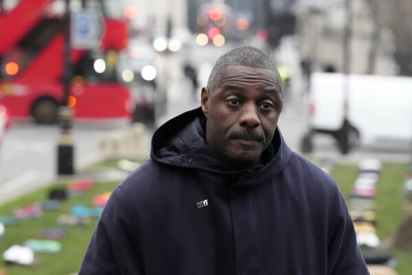 British Actor Idris Elba stands in Parliament Square with clothing representing the human cost of UK Knife Crime in London, Monday, Jan. 8, 2024, as he calls on the government to take immediate action to prevent serious youth violence. (AP Photo/Frank Augstein)