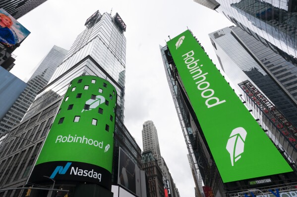 FILE - Electronic screens in New York's Times Square announce the Robinhood IPO, July 29, 2021. Robinhood Markets Inc. is buying crytocurrency exchange Bitstamp, Thursday, June 6, 2024, for about $200 million as the company looks to speed up its cryptocurrency expansion globally. (AP Photo/Mark Lennihan, File)