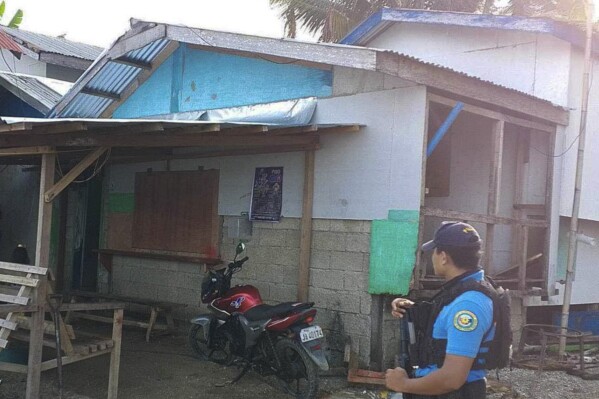 In this photo provided by the Philippine National Police Regional Office 9, a policeman checks an area Friday Oct. 18, 2024, where an American identified as Elliot Onil Eastman, from Vermont, was reportedly abducted by gunmen in Sibuco town, Zamboanga del Norte province, southern Philippines. (Philippine National Police Regional Office 9 via AP)