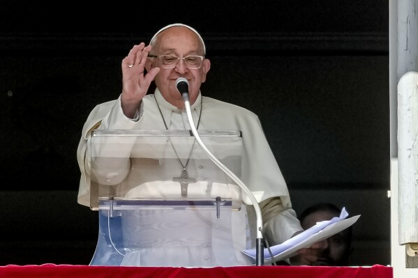 Pope Francis appears at his studio window for the traditional noon blessing of faithful and pilgrims gathered in St. Peter's Square at The Vatican, Sunday, Oct. 6, 2024. (AP Photo/Andrew Medichini)