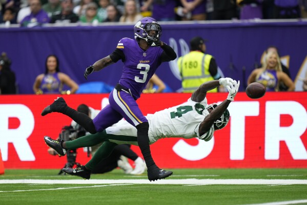 Minnesota Vikings' Jordan Addison (3), left, can't make the catch while New York Jets' D.J. Reed defends during the first half of an NFL football game, Sunday, Oct. 6, 2024, at the Tottenham Hotspur stadium in London. (AP Photo/Kirsty Wigglesworth)