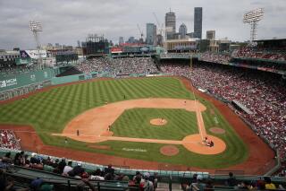 FILE - The Baltimore Orioles play against the Boston Red Sox during the eighth inning of the first baseball game of a doubleheader May 28, 2022, in Boston. Pickleball courts were being laid out in Fenway Park on Tuesday, July 11, 2023, in preparation for a weekend that will give fans of the sport a chance to watch the pros play or even give it a try themselves in the outfield of the Red Sox's historic home. (AP Photo/Michael Dwyer, File)