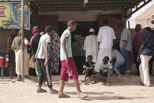 FILE -People line up in front of a bakery during a cease-fire in Khartoum, Sudan, May 27, 2023. (AP Photo/Marwan Ali, File)