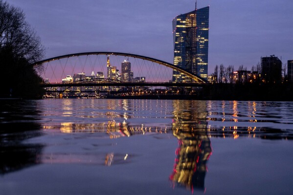 FILE - The European Central Bank is reflected in the river Main in Frankfurt, Germany, Thursday, March 21, 2024. The inflation that has squeezed European shoppers fell more than expected in March to 2.4%, as cost spikes in the grocery aisle eased and overall price rises headed down in the two biggest economies, Germany and France. (AP Photo/Michael Probst, File)