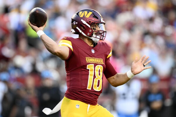 Washington Commanders quarterback Marcus Mariota throws a pass during the first half of an NFL football game against the Carolina Panthers, Sunday, Oct. 20, 2024, in Landover, Md. (AP Photo/Nick Wass)