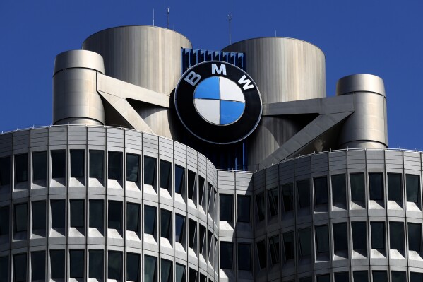 FILE - The logo of German car manufacturer BMW is fixed at the headquarters in Munich, Germany, Friday, May 14, 2021. (AP Photo/Matthias Schrader, File)