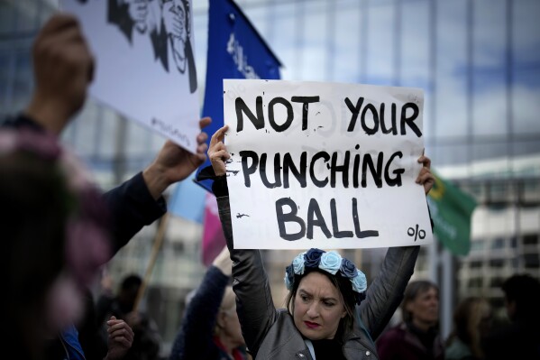 People gather to take part in a protest against sexual violence, in Paris, France, Saturday, Oct. 19, 2024. (AP Photo/Christophe Ena)