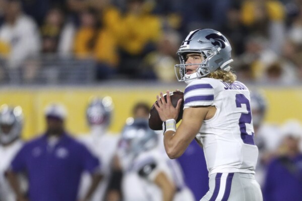 Kansas State quarterback Avery Johnson (2) makes a pass against West Virginia during the first half of an NCAA college football game, Saturday, Oct. 19, 2024, in Morgantown, W.Va. (AP Photo/William Wotring)