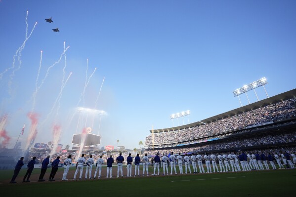 Planes fly over Dodger Stadium before Game 1 of baseball's NL Division Series between the Los Angeles Dodgers and the San Diego Padres, Saturday, Oct. 5, 2024, in Los Angeles. (AP Photo/Ashley Landis)